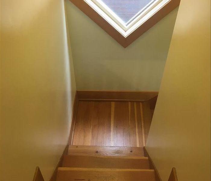 A stairwell newly re-trimmed and repainted after mitigation. 
