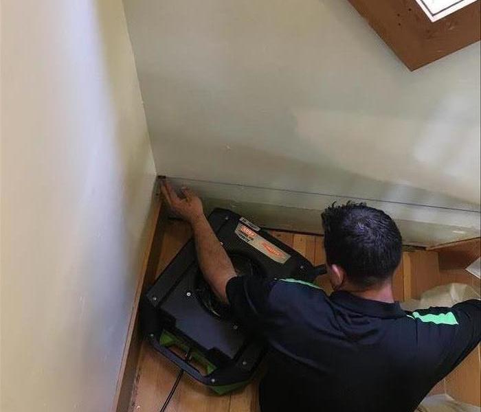 A SERVPRO of Missoula technician removes wet material in a stairwell. 