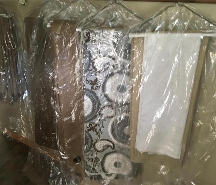 Curtains and carpets hanging in linen bags
